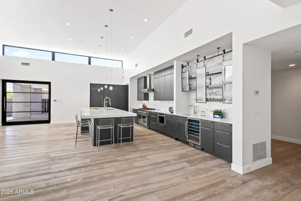 a kitchen with stainless steel appliances kitchen island granite countertop a stove a sink and a refrigerator