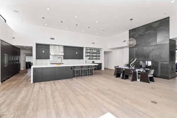 a large kitchen with stainless steel appliances a large counter top a stove a chimney a sink and a large window