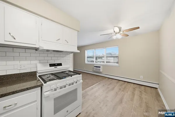 a kitchen with granite countertop a stove a sink and dishwasher