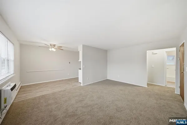 an empty room with a empty space and windows
