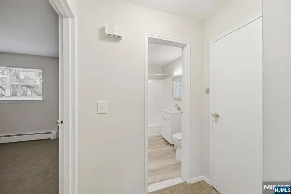 a view of a bathroom from a hallway