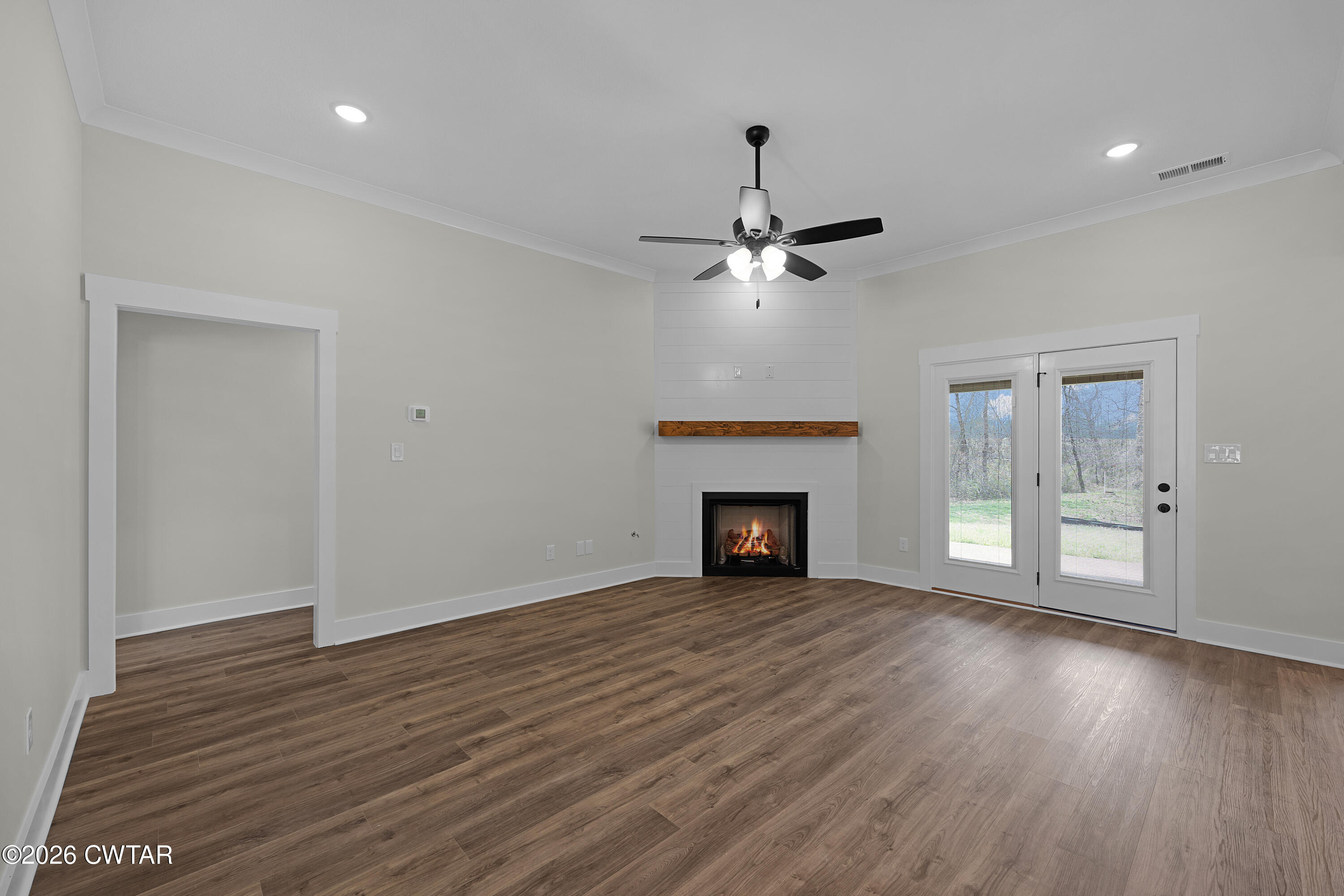 404 Fairway Boulevard Jackson, TN 38305 - Photo 3 of 16 a view of an empty room with wooden floor fireplace and a window