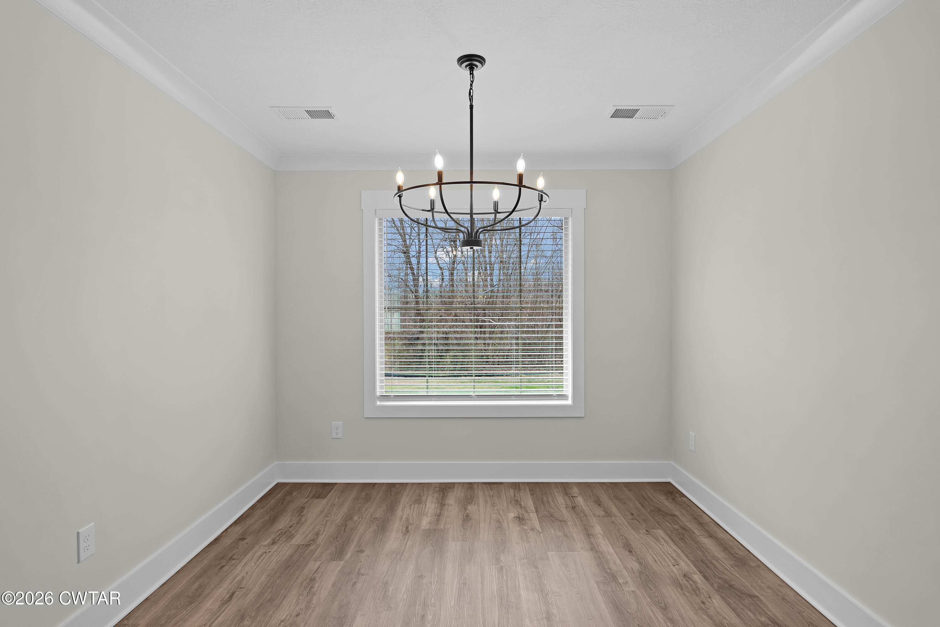 404 Fairway Boulevard Jackson, TN 38305 - Photo 7 of 16 a view of an empty room with wooden floor and a window