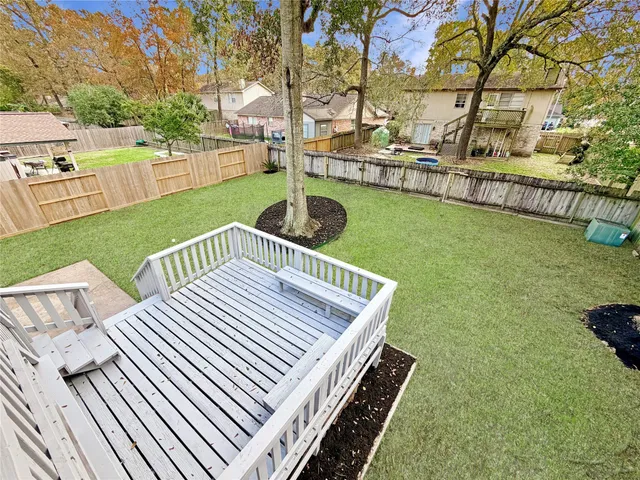 a view of a wooden deck and a yard