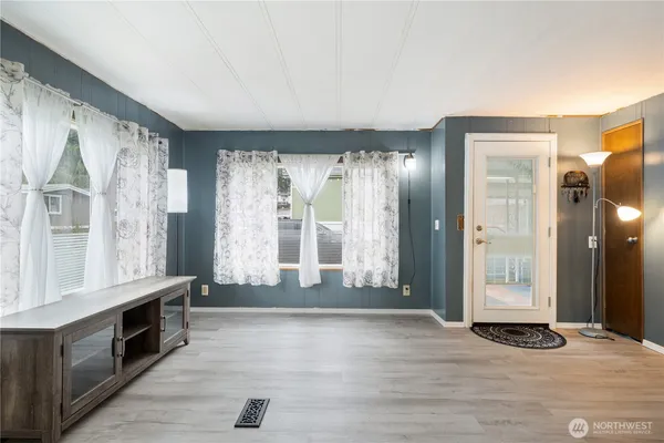 a view of entryway with wooden floor and cabinet