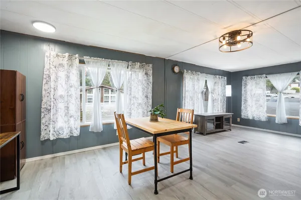 a dining room with furniture and window