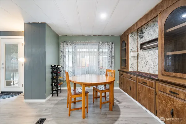 a view of a a dining room with furniture window and wooden floor