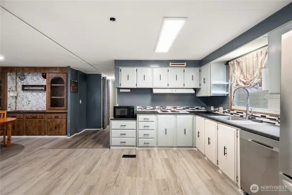 a large kitchen with stainless steel appliances granite countertop a stove and a refrigerator