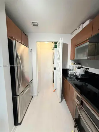 a kitchen with a refrigerator stove and microwave