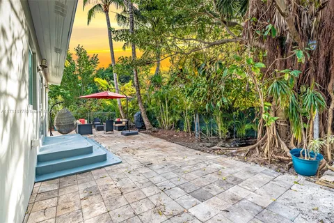 a view of a backyard with a patio and plants