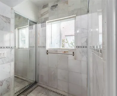 a bathroom with a glass shower door