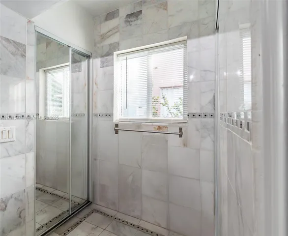 a bathroom with a glass shower door