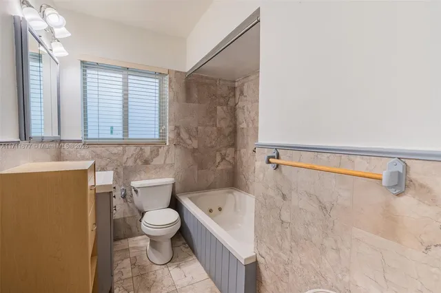 a bathroom with a toilet a sink and a bathtub