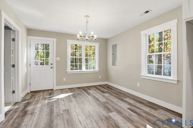 wooden floor in an empty room with a window