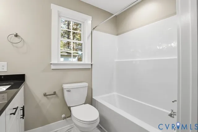 a white toilet sitting next to a bath tub
