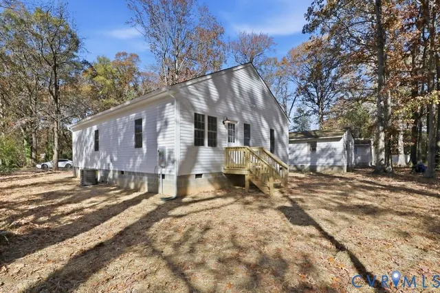 a view of a house with a yard covered in snow
