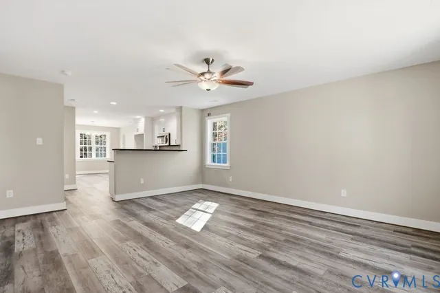 a view of a kitchen with wooden floor and a kitchen