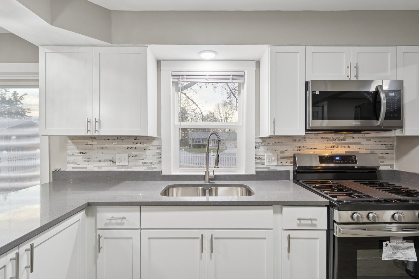 519 South Sycamore Street Genoa, IL 60135 - Photo 11 of 36 a kitchen with appliances a sink and cabinets
