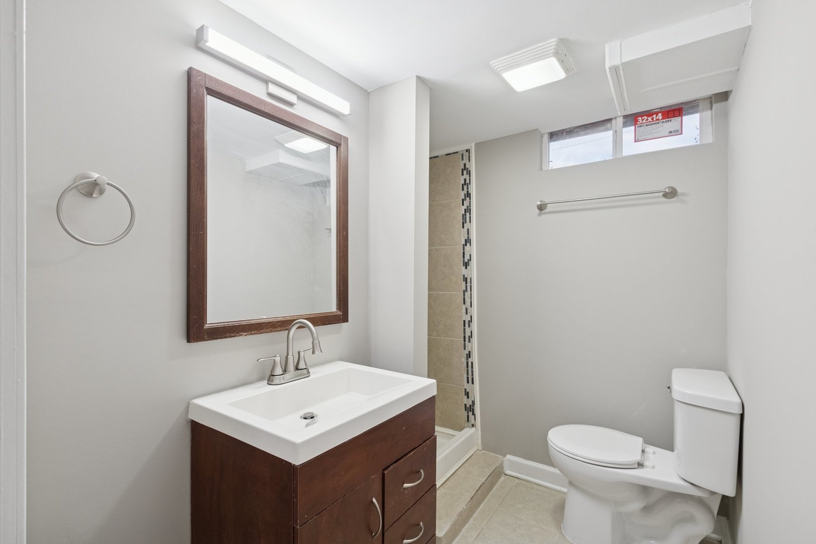 519 South Sycamore Street Genoa, IL 60135 - Photo 14 of 36 a bathroom with a toilet a sink a mirror and a shower