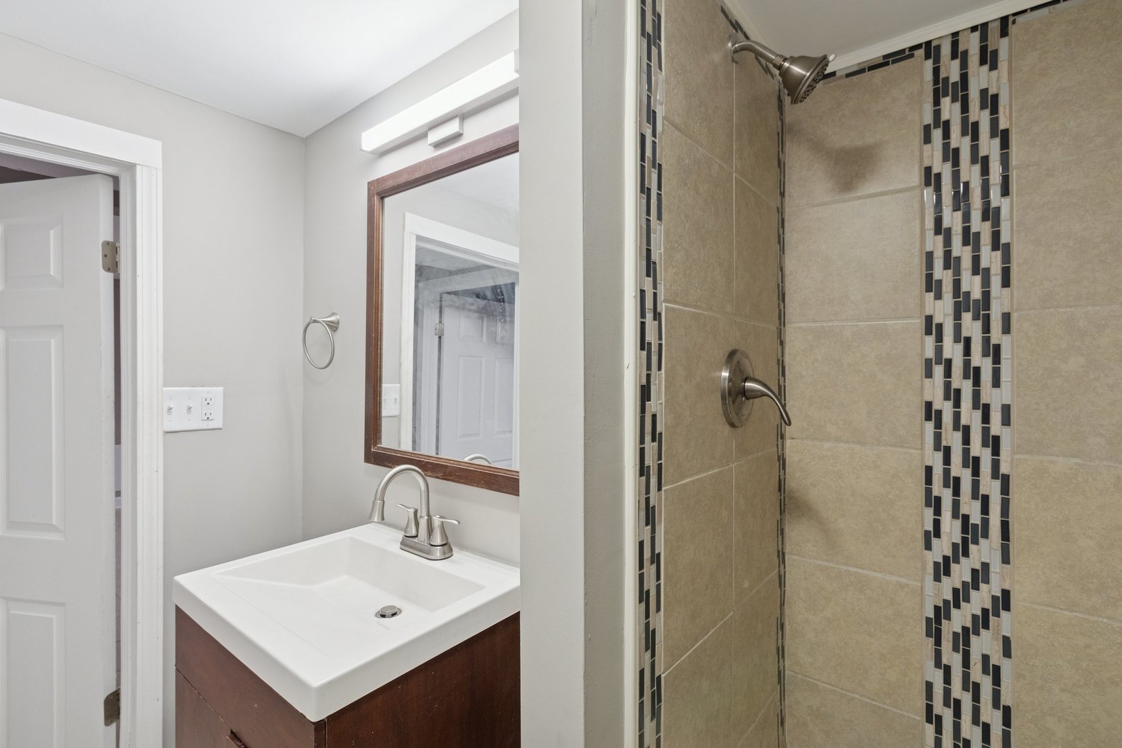 519 South Sycamore Street Genoa, IL 60135 - Photo 15 of 36 a bathroom with a sink mirror and shower