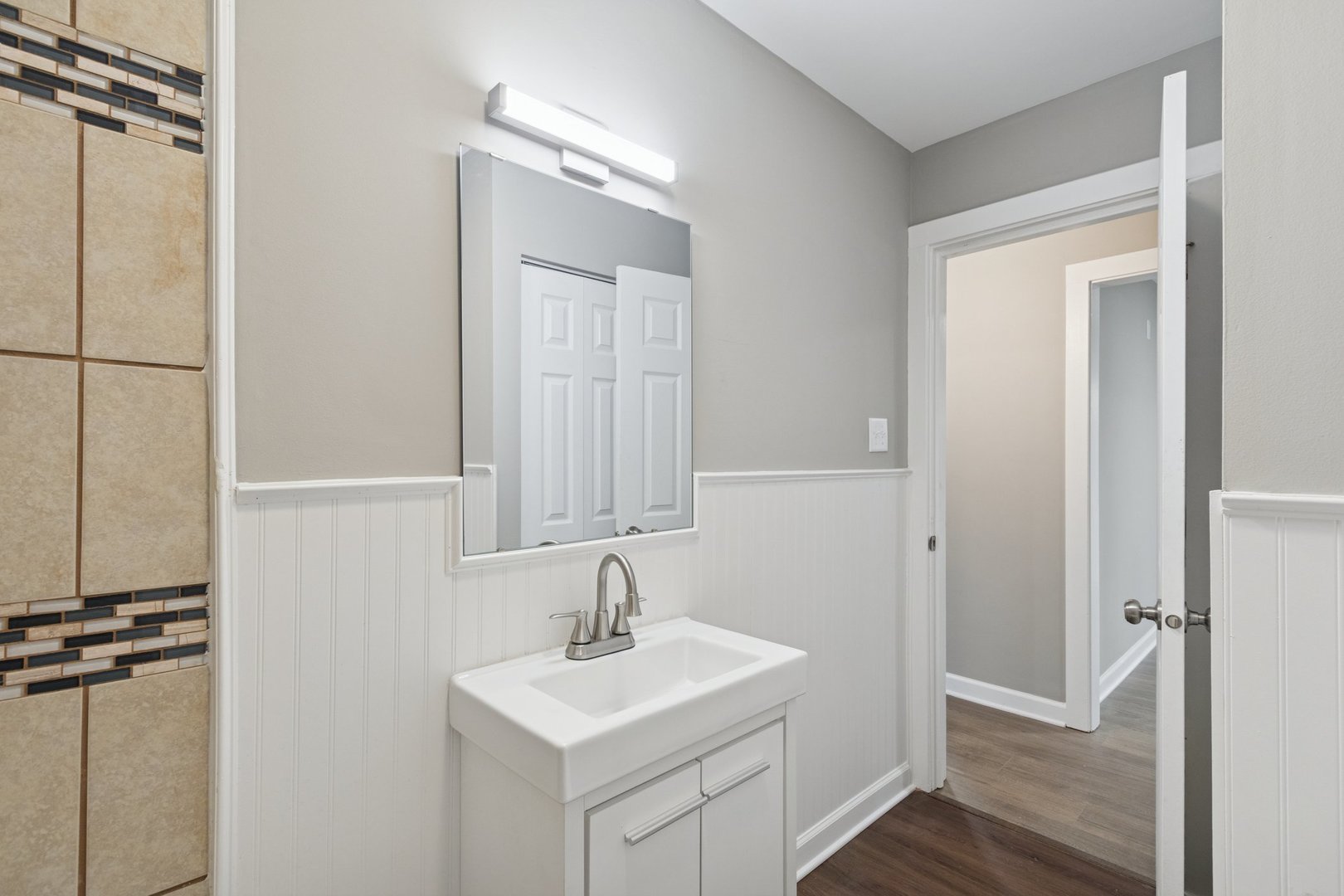 519 South Sycamore Street Genoa, IL 60135 - Photo 21 of 36 a bathroom with a sink a mirror and shower