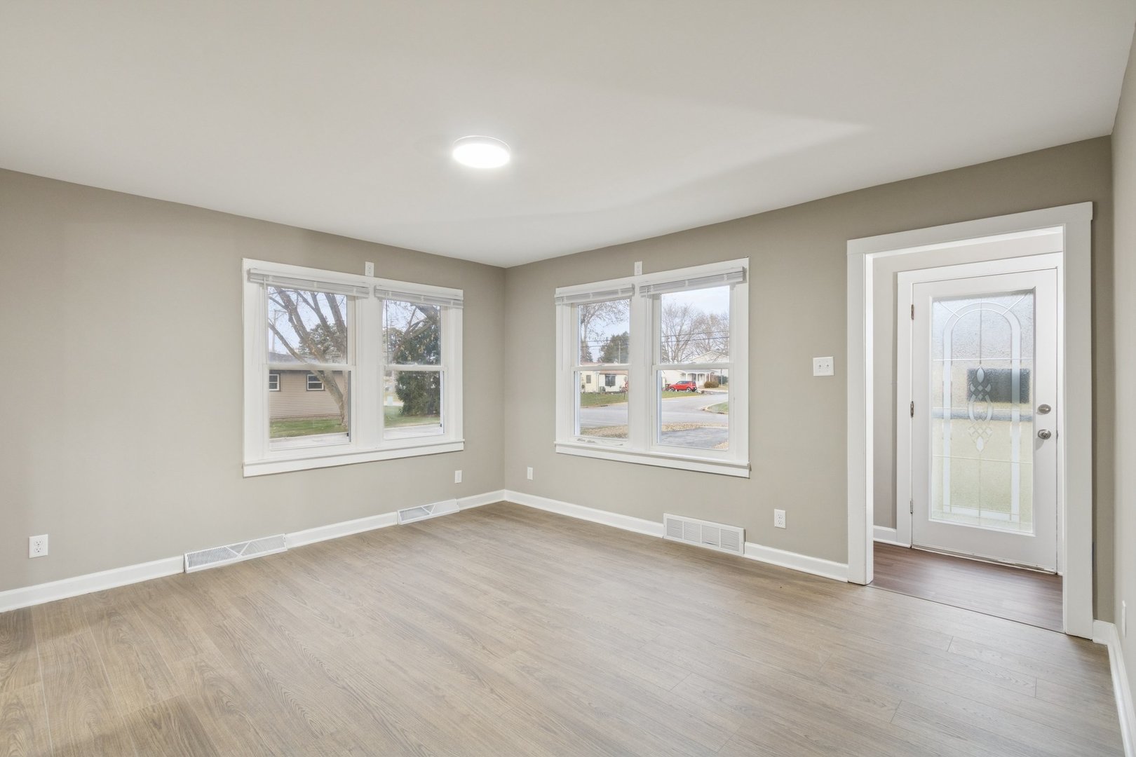 519 South Sycamore Street Genoa, IL 60135 - Photo 4 of 36 a view of an empty room with a window