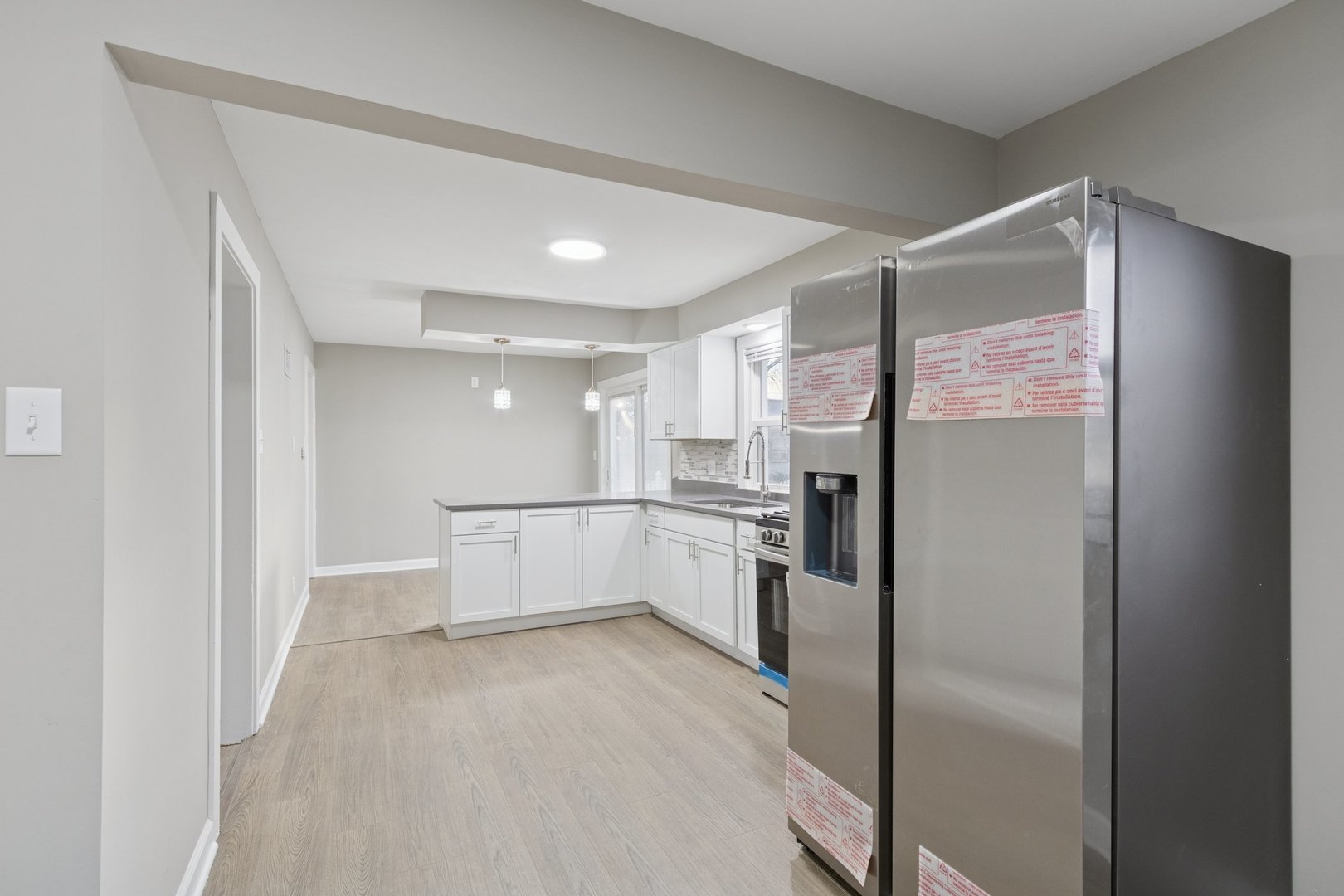 519 South Sycamore Street Genoa, IL 60135 - Photo 9 of 36 a view of a refrigerator in kitchen and an empty room
