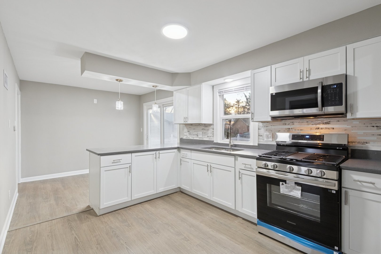 519 South Sycamore Street Genoa, IL 60135 - Photo 10 of 36 a kitchen with stainless steel appliances a stove microwave and sink
