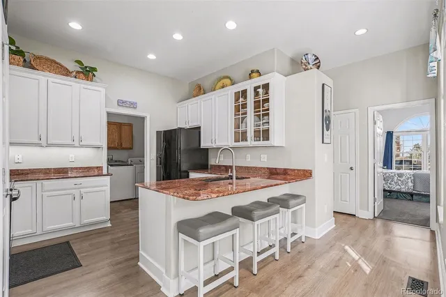 a dining hall with stainless steel appliances granite countertop a stove and a refrigerator