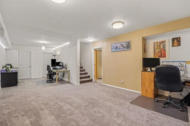 a view of a workspace with furniture and a projector
