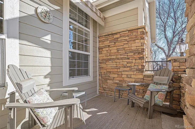 a view of a patio with table and chairs and wooden floor