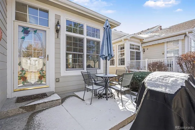 a view of a patio with table and chairs