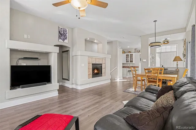 a living room with furniture flat screen tv and a fireplace