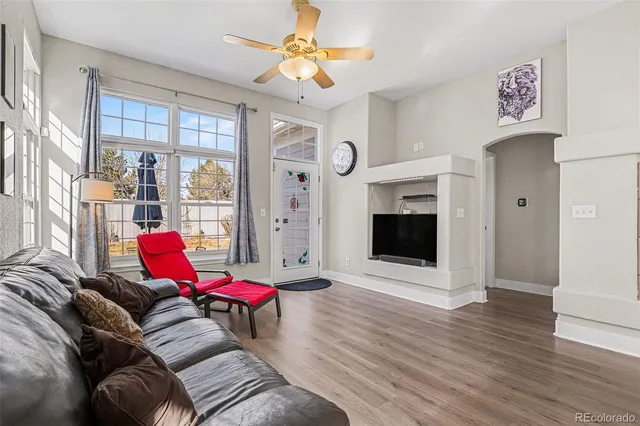 a living room with furniture and a fireplace