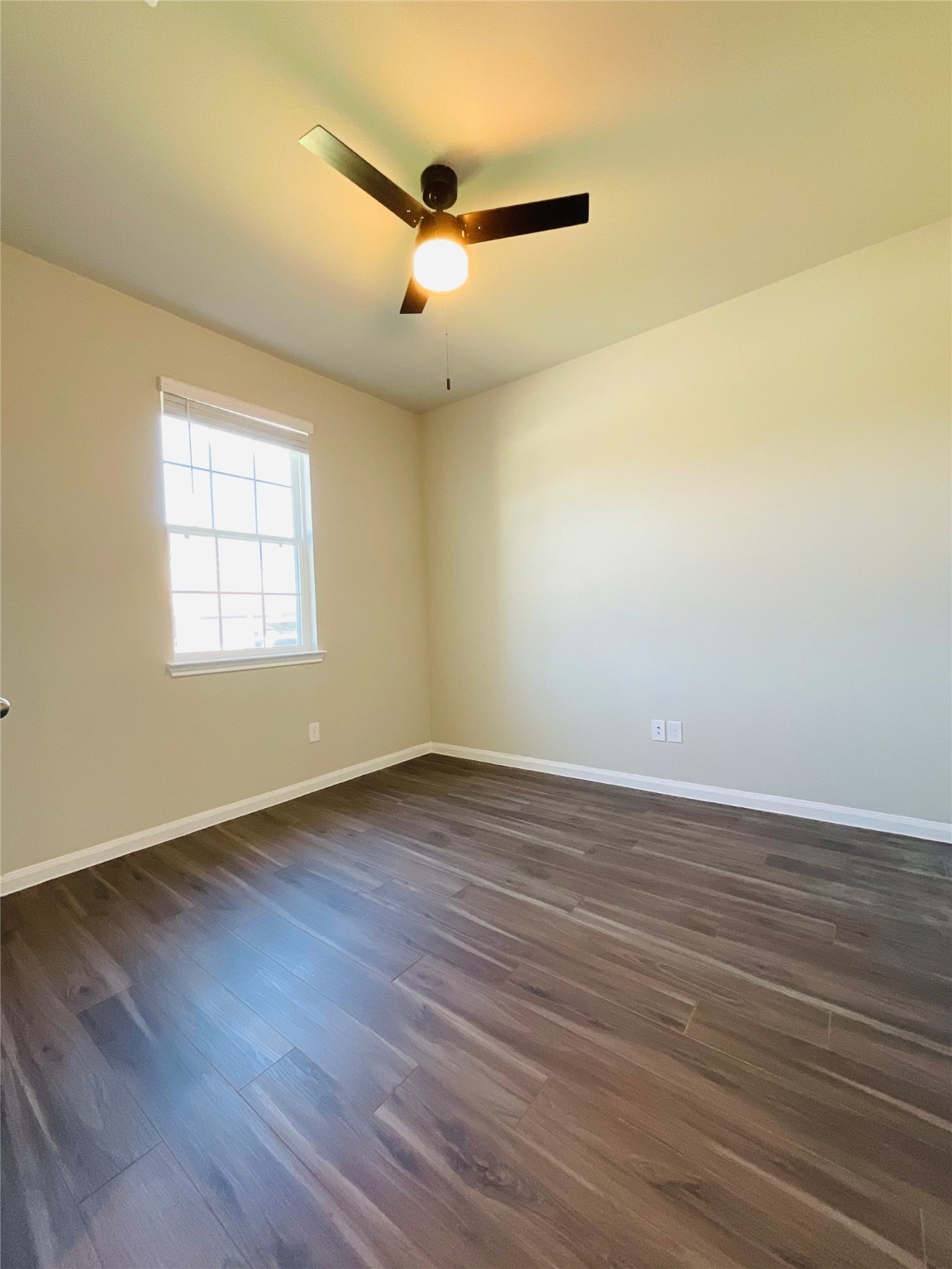 5311 Briana Dee Drive Rosharon, TX 77583 - Photo 2 of 21 an empty room with wooden floor fan and windows