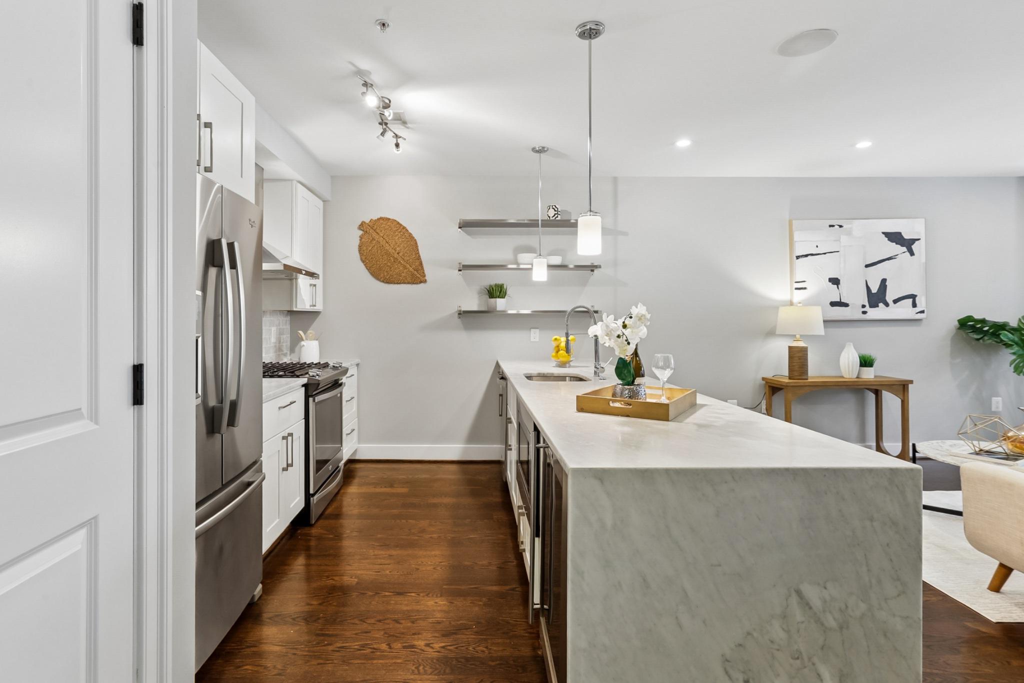 1311 K Street Southeast, Unit 1 Washington, DC 20003 - Photo 7 of 33 Marble waterfall counter & stainless appliances.