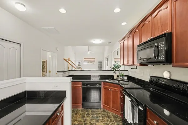 a kitchen with stainless steel appliances a stove sink microwave and cabinets