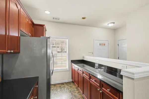 a kitchen with stainless steel appliances granite countertop a stove and a refrigerator