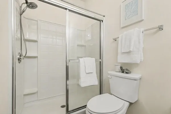a white toilet sitting next to a bathroom sink