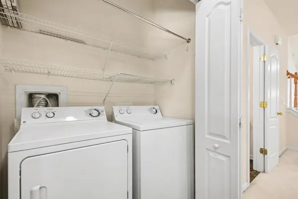 a view of storage and utility room with washer and dryer