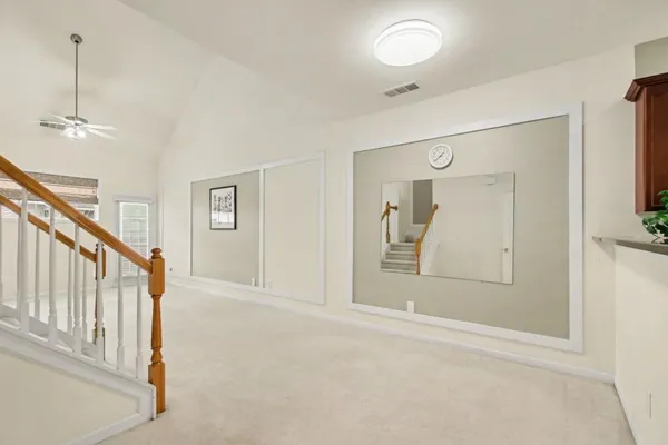 a view of a hallway with wooden floor and cabinet