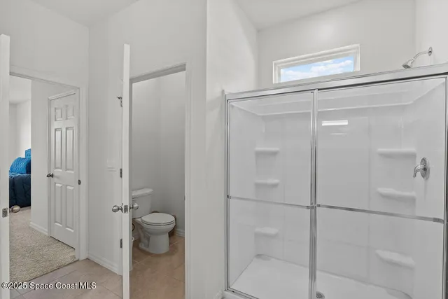a bathroom with a glass shower door