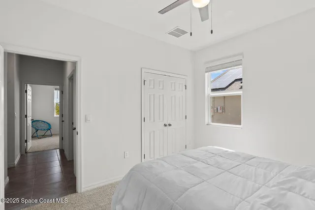 a view of a bedroom with a furniture and wooden floor