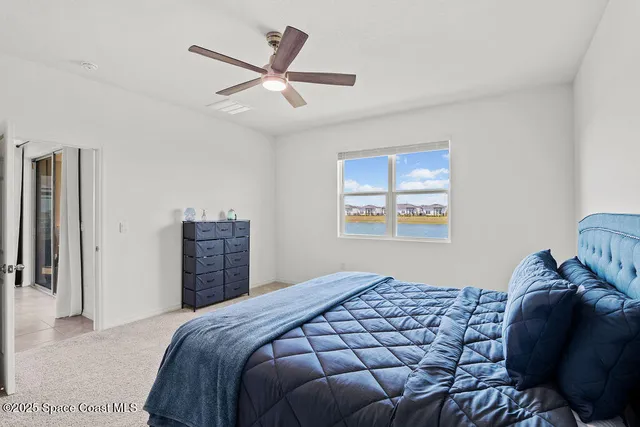a bedroom with a large bed and a window