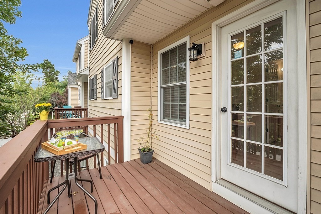 417 Hildreth Street, Unit 3 Lowell, MA 01850 - Photo 11 of 37 a balcony with table and chairs