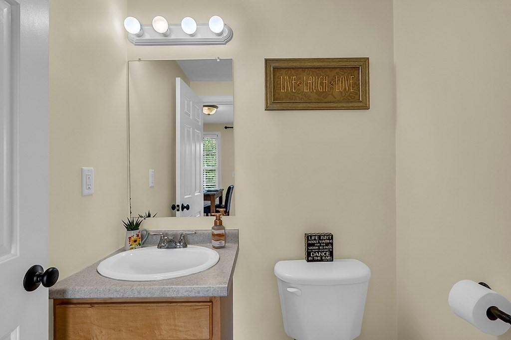 417 Hildreth Street, Unit 3 Lowell, MA 01850 - Photo 13 of 37 a bathroom with a toilet a sink and mirror