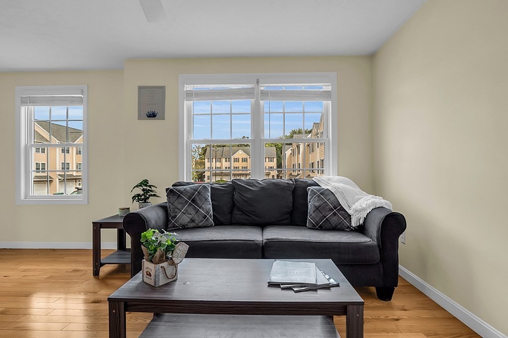 417 Hildreth Street, Unit 3 Lowell, MA 01850 - Photo 16 of 37 a living room with furniture and wooden floor