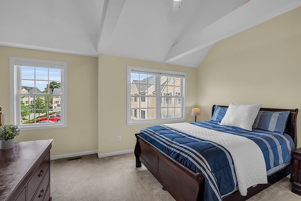 417 Hildreth Street, Unit 3 Lowell, MA 01850 - Photo 19 of 37 a bed sitting in a bedroom next to a window