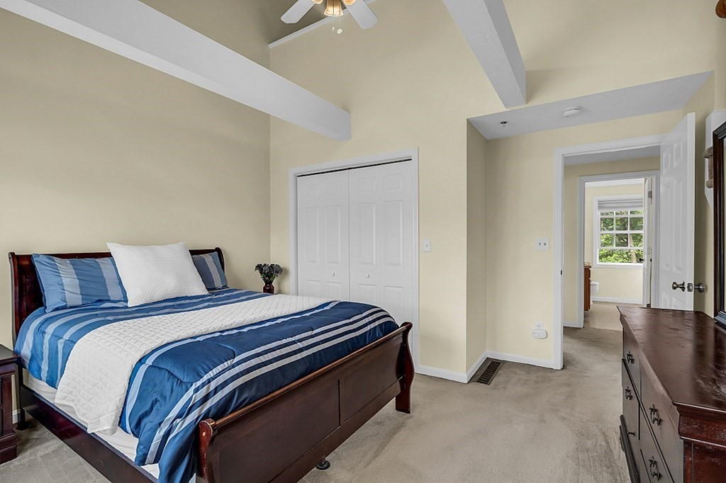 417 Hildreth Street, Unit 3 Lowell, MA 01850 - Photo 20 of 37 a spacious bedroom with a bed and cabinets