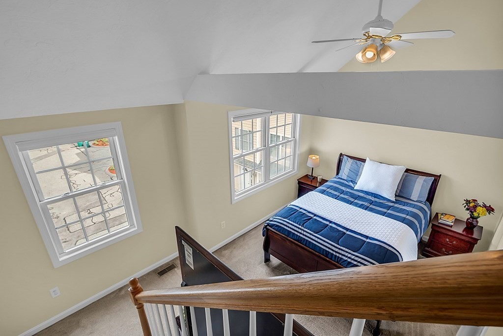 417 Hildreth Street, Unit 3 Lowell, MA 01850 - Photo 23 of 37 a bedroom with bed and wooden floor